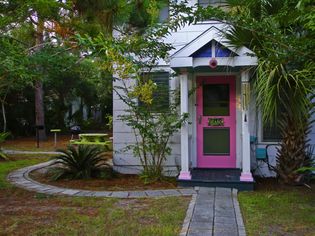 Pink front door of beach cottage