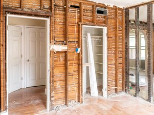 Home interior being rebuilt with exposed wood structure beams