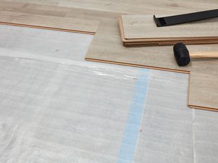 Underlayment exposed with planks being installed