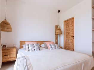 Mediterranean villa guest bedroom with wicker decor accents