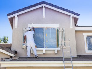 House painter painting a home exterior