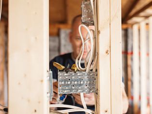 Electrician installing electricity, generating power in a home remodel