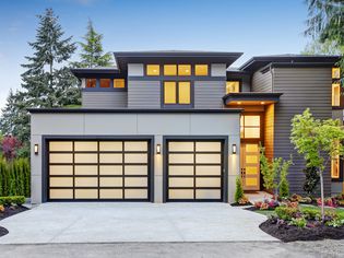 Luxury modern home with a glass garage door