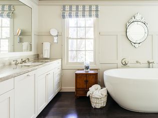 Dark hardwood flooring in bright and neutral bathroom