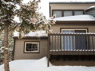 Brown home and tree covered with snow in winter