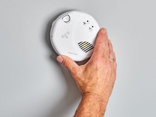 Hardwired smoke detector installed on wall 