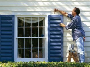 Man Painting vinyl shutters