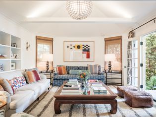 Naturally-lit living room mixed with modern and antique furniture