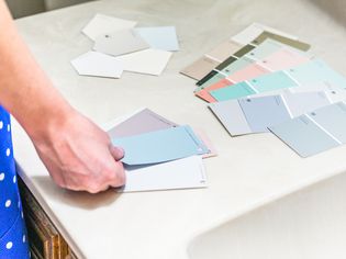 person looking at paint swatches