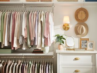 Inside of a closet with light fixture on wall