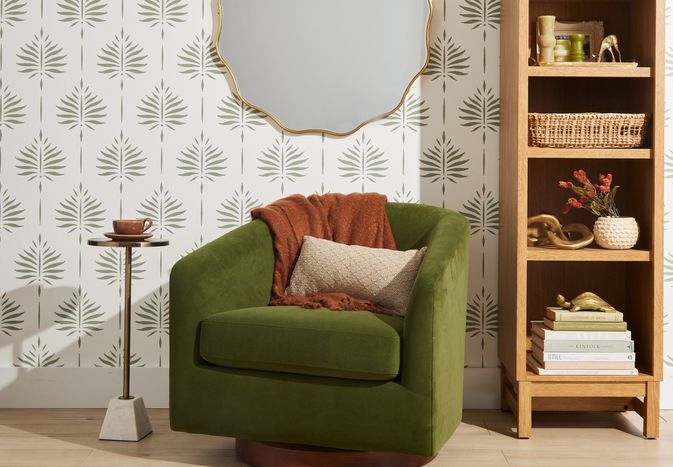 Green armchair with leaf-patterned wallpaper