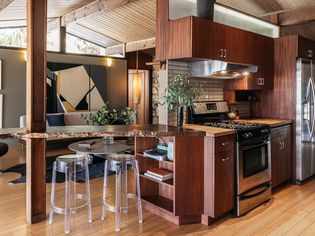 Taupe painted wall behind Midcentury modern designed kitchen 